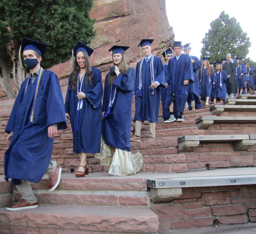 Members of the Evergreen High School class of 2021 walk down the stairs at Red Rocks Amphitheatre at the start of the graduation ceremony on May 20.